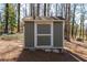Outdoor shed for storing gardening tools and lawn care equipment. Storage building has a green paint with white trim at 5836 Trailwoods Ct, Stone Mountain, GA 30087