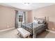 Inviting bedroom showcasing ample natural light, plush carpet, and a sleek, modern bed frame at 612 Kristen Ct, Mcdonough, GA 30252