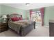 Cozy bedroom with a plush bed, soft carpeting, and a bright window with cherry blossom views at 612 Kristen Ct, Mcdonough, GA 30252
