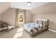 Bright bedroom featuring vaulted ceilings, a large window, and neutral decor for a tranquil retreat at 612 Kristen Ct, Mcdonough, GA 30252