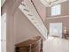 Elegant foyer featuring tile flooring, a staircase, and a bright window, creating a grand entrance at 612 Kristen Ct, Mcdonough, GA 30252