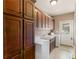 Functional laundry room with washer, dryer, sink, and lots of storage cabinets for added convenience at 612 Kristen Ct, Mcdonough, GA 30252