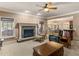 Inviting living room featuring a stone fireplace, neutral carpet, and plenty of natural light at 612 Kristen Ct, Mcdonough, GA 30252