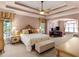 Spacious main bedroom with tray ceilings, plush carpeting, and a dedicated office space at 612 Kristen Ct, Mcdonough, GA 30252
