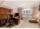 Comfortable office with built-in shelving, a large window, and a cozy chaise lounge at 612 Kristen Ct, Mcdonough, GA 30252