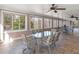 Sunroom with tiled floor featuring plenty of windows and chairs at 612 Kristen Ct, Mcdonough, GA 30252