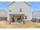 Back of home with patio, pergola, grill, and fenced-in yard at 133 Prominence Ct, Canton, GA 30114