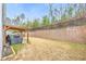 Backyard featuring a patio, grill, and wooden fence, perfect for outdoor entertaining at 133 Prominence Ct, Canton, GA 30114