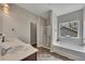 A bathroom featuring a large soaking tub, shower, double vanity, and neutral color palette at 133 Prominence Ct, Canton, GA 30114