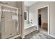 Well-lit bathroom features a large shower and tub and an adjacent door to the walk-in closet at 133 Prominence Ct, Canton, GA 30114