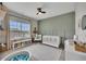 Charming Bedroom featuring a crib, changing table, and playful decor accents at 133 Prominence Ct, Canton, GA 30114