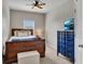 Well-lit bedroom with wooden bed frame, side table, and window at 133 Prominence Ct, Canton, GA 30114