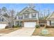Charming two-story home with a two-car garage, stone accents, and landscaped front yard at 133 Prominence Ct, Canton, GA 30114