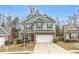 Charming two-story home with a two-car garage, stone accents, and landscaped front yard at 133 Prominence Ct, Canton, GA 30114