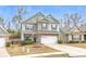 Charming two-story home with a two-car garage, stone accents, and landscaped front yard at 133 Prominence Ct, Canton, GA 30114