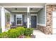 Inviting front porch features rocking chairs, stone accents, and a charming entrance at 133 Prominence Ct, Canton, GA 30114