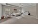 Spacious main bedroom featuring a large bed, white rug, and a comfortable armchair at 133 Prominence Ct, Canton, GA 30114