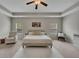 A spacious primary bedroom features a large bed, a comfortable chair, and abundant natural light at 133 Prominence Ct, Canton, GA 30114