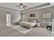 This primary bedroom boasts a large bed and plentiful natural light from surrounding windows at 133 Prominence Ct, Canton, GA 30114