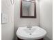 Charming powder room features a pedestal sink, decorative mirror and updated fixtures at 2840 Ivy Mill Dr, Buford, GA 30519