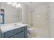 Clean bathroom with a blue vanity, a white toilet, and a shower and tub combo at 2840 Ivy Mill Dr, Buford, GA 30519