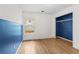 Bedroom with blue accent wall, hardwood floors, and closet space at 2840 Ivy Mill Dr, Buford, GA 30519