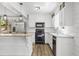 Well-lit kitchen with white cabinets, granite countertops, stainless steel appliances, and wood-look flooring at 2840 Ivy Mill Dr, Buford, GA 30519