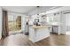 Spacious kitchen featuring a stainless steel refrigerator, granite countertops, white cabinets, and a large window at 2840 Ivy Mill Dr, Buford, GA 30519