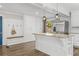 Bright kitchen with white cabinets, a large island with stone countertop, stainless steel appliances, and wood-look flooring at 2840 Ivy Mill Dr, Buford, GA 30519