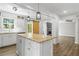 Open kitchen with a granite island, stainless steel dishwasher, and a view of the living room with a fireplace at 2840 Ivy Mill Dr, Buford, GA 30519