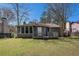 Well-maintained backyard with green grass and a wood porch at 910 Brandon Hill Way, Jonesboro, GA 30238
