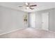 Spacious bedroom featuring plush carpet, ceiling fan, and lots of closet space at 910 Brandon Hill Way, Jonesboro, GA 30238