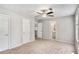 Bright, airy bedroom with ceiling fan and neutral carpet, offering ample closet space and natural light at 910 Brandon Hill Way, Jonesboro, GA 30238