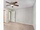 Neutral bedroom featuring a ceiling fan, carpet, and multiple doors at 910 Brandon Hill Way, Jonesboro, GA 30238