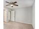 Neutral bedroom features a ceiling fan, carpet flooring, and closet space for all your storage needs at 910 Brandon Hill Way, Jonesboro, GA 30238
