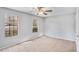 Light-filled bedroom with two windows and neutral carpet, providing a serene and comfortable atmosphere at 910 Brandon Hill Way, Jonesboro, GA 30238