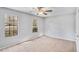 Comfortable bedroom featuring natural light through two windows and neutral carpeting at 910 Brandon Hill Way, Jonesboro, GA 30238