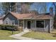 Charming single-story home featuring stone accents, a well-manicured lawn, and a cozy, inviting entrance at 910 Brandon Hill Way, Jonesboro, GA 30238