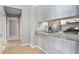 Open kitchen design with stainless steel appliances, granite countertops, and a pass-through to the dining area at 910 Brandon Hill Way, Jonesboro, GA 30238