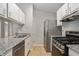 Well-equipped kitchen with stainless steel appliances, including a gas range and dishwasher, granite countertop at 910 Brandon Hill Way, Jonesboro, GA 30238