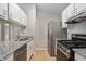 Well-equipped kitchen featuring stainless steel appliances, granite counters, and ample storage space at 910 Brandon Hill Way, Jonesboro, GA 30238