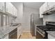 Modern kitchen with granite countertops, stainless steel appliances, and ample cabinet space for storage at 910 Brandon Hill Way, Jonesboro, GA 30238