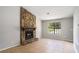 Bright living room featuring a stone fireplace and view to the backyard at 910 Brandon Hill Way, Jonesboro, GA 30238