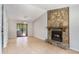 Open living area with tile flooring, a stone fireplace, and sliding glass doors to the outside at 910 Brandon Hill Way, Jonesboro, GA 30238