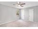 Spacious main bedroom with neutral carpet, ceiling fan, and a view to the outside at 910 Brandon Hill Way, Jonesboro, GA 30238