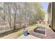 Spacious backyard featuring a patio, lush greenery, a charming deck, and a well-maintained garden bed for outdoor enjoyment at 2205 Capella Sw Cir, Atlanta, GA 30331