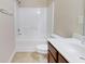 Bright bathroom featuring a bathtub with shower, toilet and vanity with a white sink at 2205 Capella Sw Cir, Atlanta, GA 30331