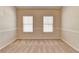 Empty bedroom showcasing two windows, neutral walls, and a clean, carpeted space ready for personalization at 2205 Capella Sw Cir, Atlanta, GA 30331
