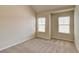 Neutral bedroom with large windows providing natural light and plush carpeting at 2205 Capella Sw Cir, Atlanta, GA 30331