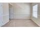 Empty bedroom with a window and a door, bright and neutral with carpeted floors at 2205 Capella Sw Cir, Atlanta, GA 30331